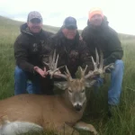 3 men with a deer kill