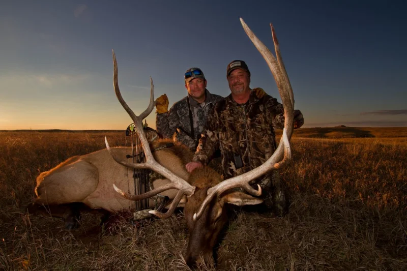 two hunters with their elk kill