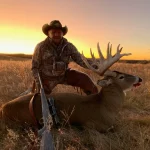 Man with elk at sunset