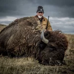 man with buffalo kill